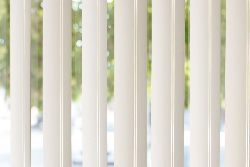 A photo of white blinds on a window